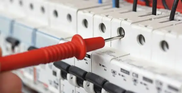 Electrical contractor testing circuit breakers during electrical repair in Gwynn Oak, MD