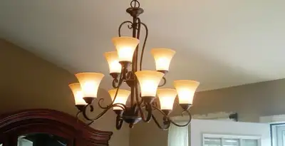 Classic ceiling chandelier installation with warm lighting in Baltimore, MD