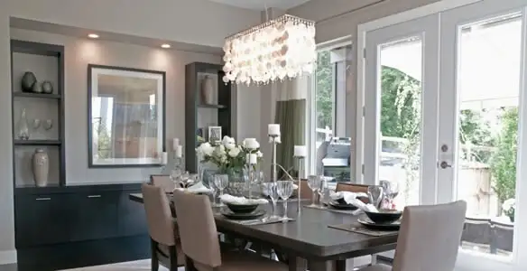 Elegant dining room chandelier installation above table in Baltimore, MD