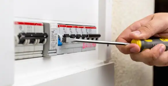 electrical panel upgrade service showing technician adjusting circuit breakers during system upgrade in Baltimore, MD