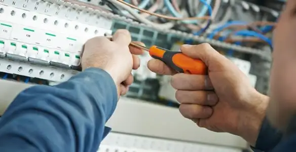 electrical service showing licensed electrician performing electrical panel maintenance and adjustments in Baltimore, MD