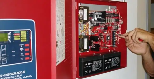 fire alarm installation service showing technician configuring fire alarm control panel in Baltimore, MD