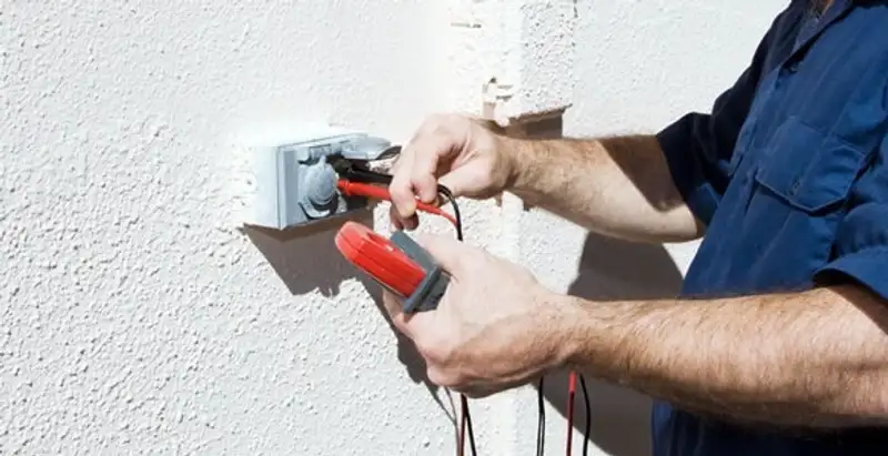 Electrician performing home electrical outlet and wiring inspection in Baltimore, MD