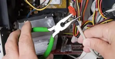 Licensed electrical contractor performing electrical repair with tools in Gwynn Oak, MD
