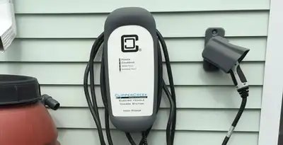 Outdoor electric vehicle charger installation on residential wall in Baltimore, MD