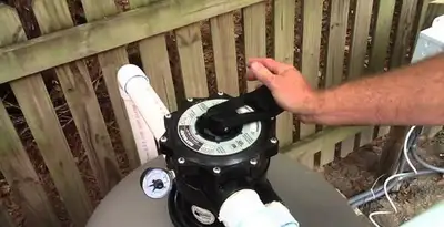 pool pumps service showing professional adjustment of pool pump control system in Baltimore, MD