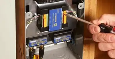 Whole home surge protection device being installed by a licensed electrician to protect electrical systems in Baltimore, MD